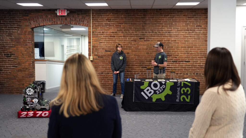 Vermont State Board of Education viewing a demonstration by iBots program members, showcasing their competition robot.