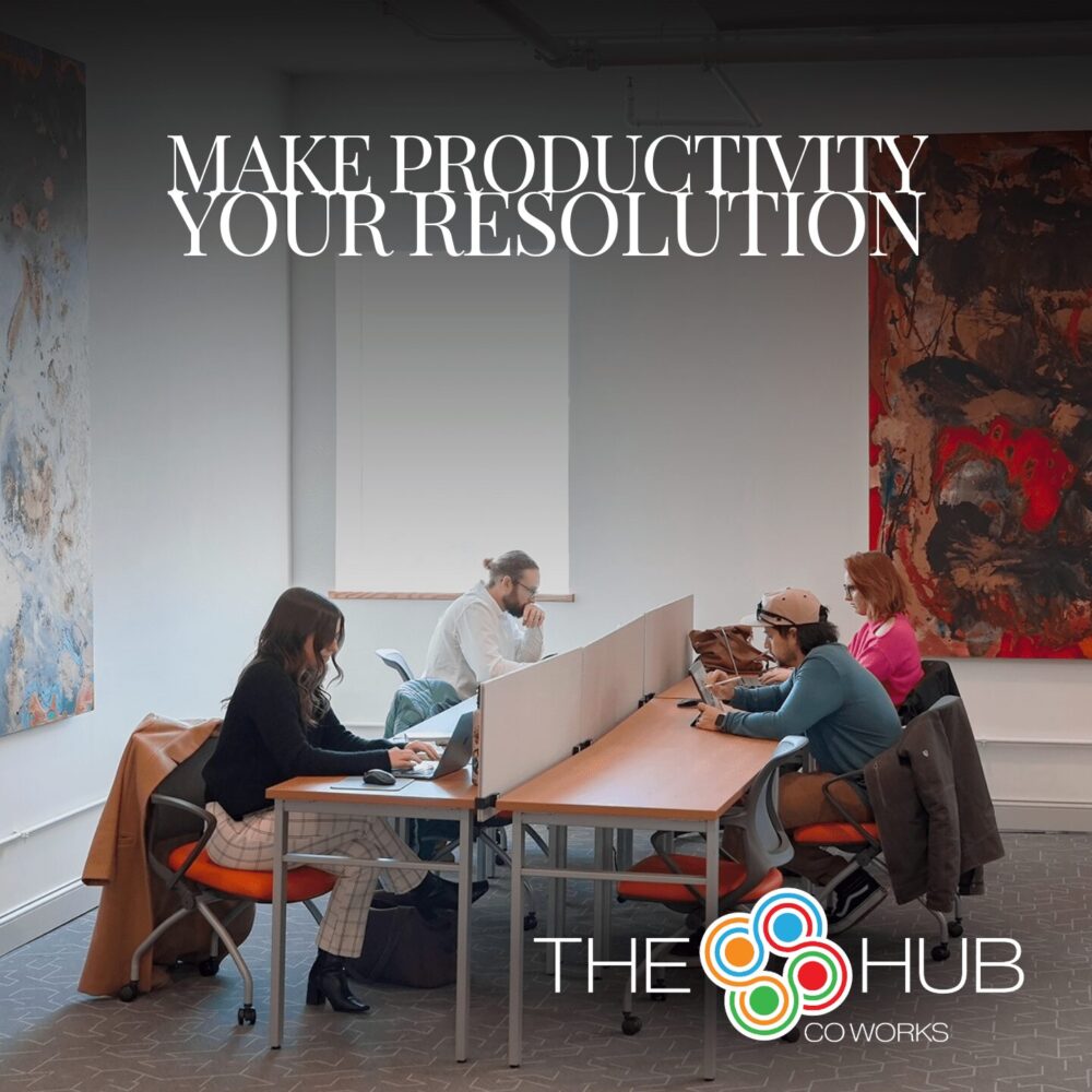 A promotional graphic for The Hub CoWorks featuring a group of four individuals working in a modern coworking space. The workspace has a clean, bright atmosphere with natural light and vibrant, abstract artwork on the walls. Overlaid on a black gradient at the top is the text, “MAKE PRODUCTIVITY YOUR RESOLUTION” in bold, white font. The Hub CoWorks logo is prominently displayed in the bottom right corner, adding a professional and welcoming touch.